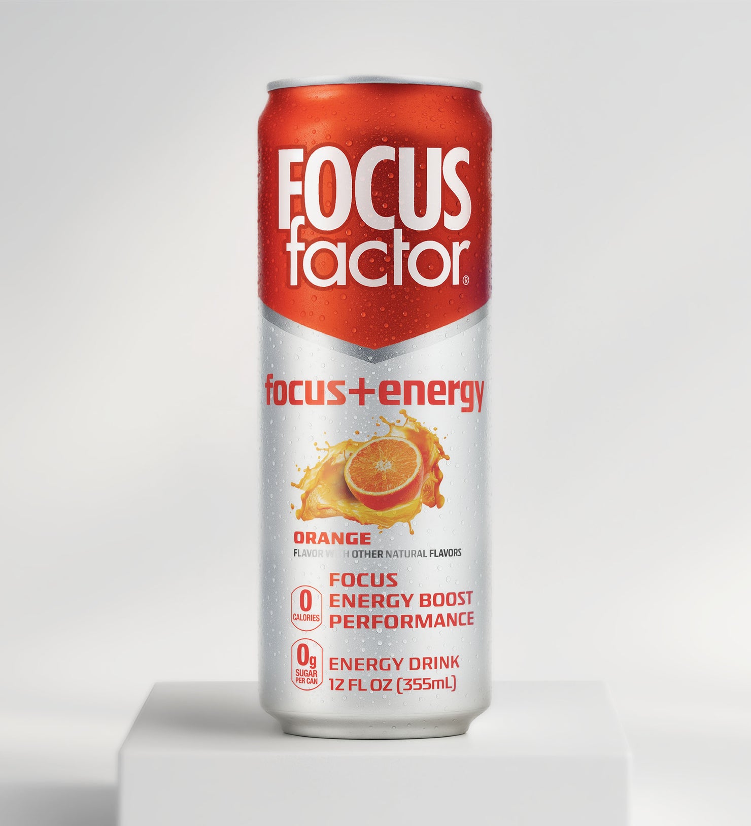 A can of Focus + Energy Drink - Orange Flavor from Focus + Energy Drinks stands upright on a white surface. The red and silver 12 fl oz (355ml) can displays an orange slice, promising nootropics for boosted focus and energy.