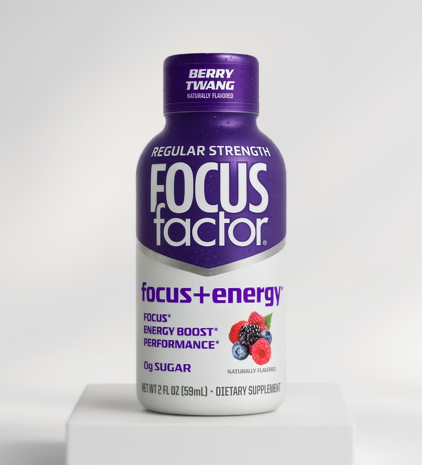 A 2 fl oz (59ml) small purple bottle of Focus + Energy Shot - Regular Strength by Focus + Energy, Berry Twang flavor, with berry images. Promotes focus, energy boost, and performance. Contains 0g sugar.