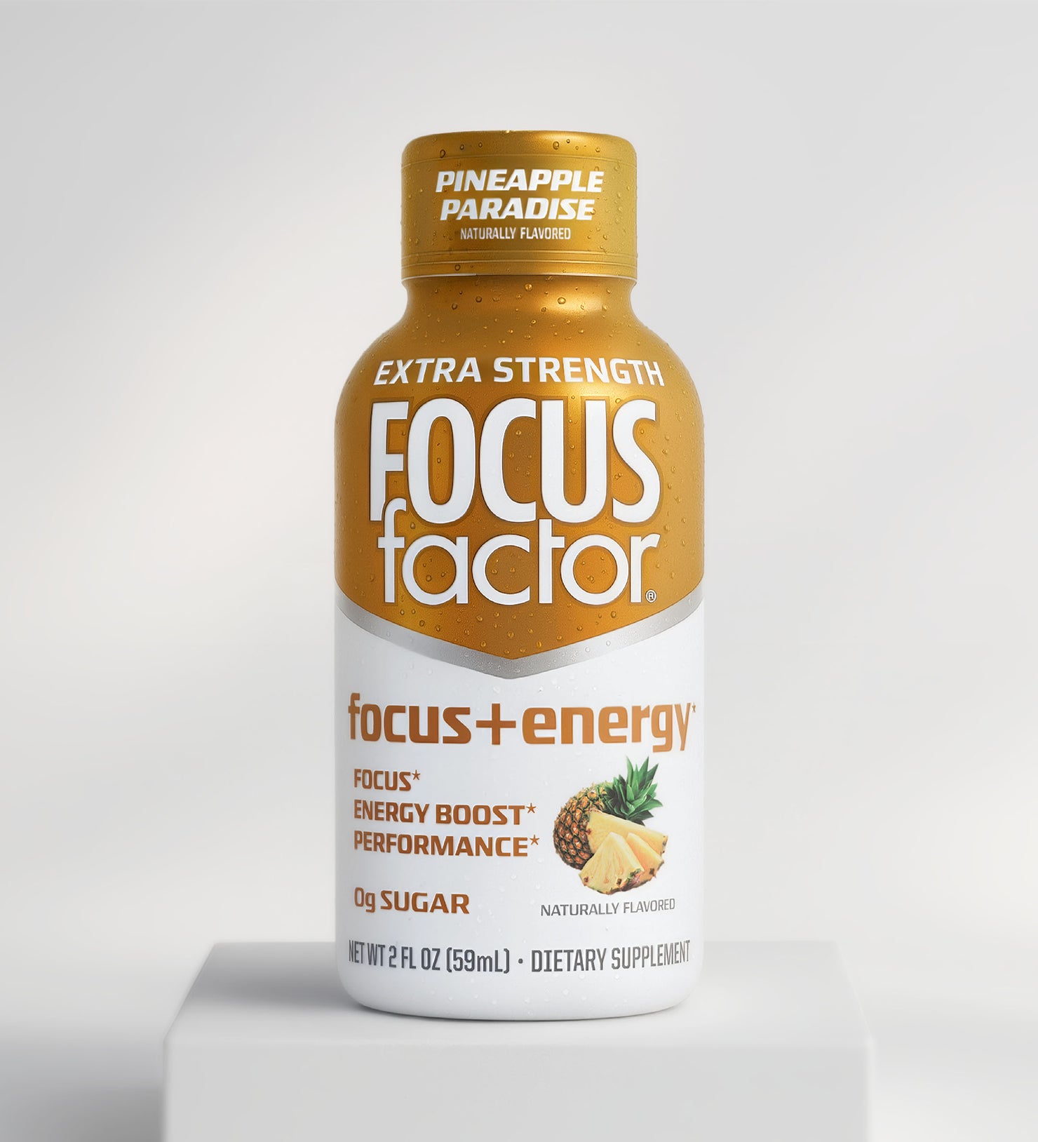 A bottle of Focus + Energy Shot - Extra Strength in Pineapple Paradise flavor by Focus + Energy, with a yellow cap and label featuring pineapple images and text for focus, energy boost, and zero sugar.